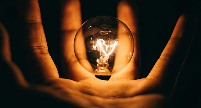 hand holding light lightbulb electricity energy Materials harvest electricity from wasted heat